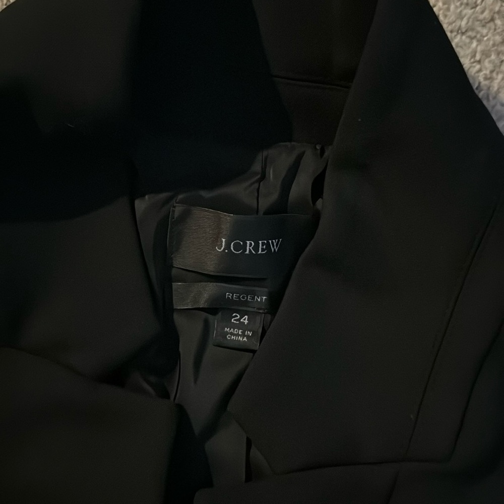 Woman’s black suit jacket.